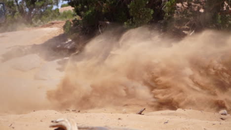 Motocross-dirt-motorcycle-spins-out-in-Slo-Mo,-sending-sand-flying