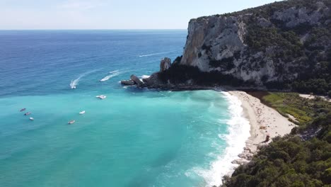 stunnig-drone-flight-over-the-famous-sardinian-beach-"cala-luna"-with-crystal-clear-skies-and-some-waves
