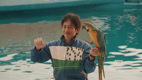 Parrot-And-Its-Trainer-Waving-At-The-Audience-During-The-Animal-Show-At-Sendai-Umino-Mori-Aquarium-In-Japan---medium-shot