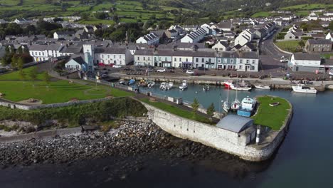 Aerial-view-of-Carnlough-harbour-and-town-on-a-sunny-day,-County-Antrim,-Northern-Ireland