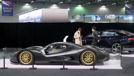 Visitors-look-at-the-Japanese-exclusive-luxury-supercar-Aspark-Owl-is-seen-displayed-during-the-International-Motor-Expo-in-Hong-Kong