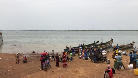 African-People-lining-up-to-board-a-ferry,-lake-volta