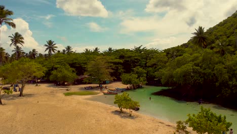Caño-Frio-natural-pool-meets-the-ocean-at-Playa-Rincón-Beach,-Dominican-Republic--Aerial