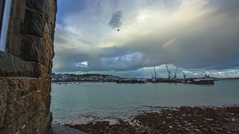Time-lapse-shot-of-luxury-yacht-docking-on-Harbor-of-Guernsey-Island-during-cloudy-day-at-Saint-Peter-Port