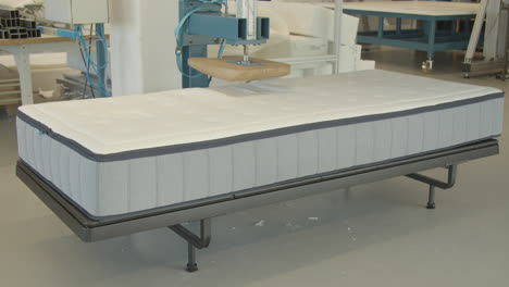 Wooden-butt-shaped-press-testing-quality-of-new-matress-in-testing-facility---wide