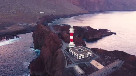 Majestic-lighthouse-of-Tenerife-island-on-rocky-coastline,-aerial-fly-towards-view