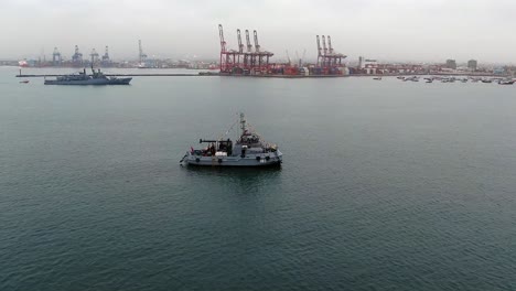 Peruvian-Naval-Ship-RAS-180-BAP-Morales-Sailing-Across-The-Ocean-In-Peru-With-Port-Of-Callao-In-Background