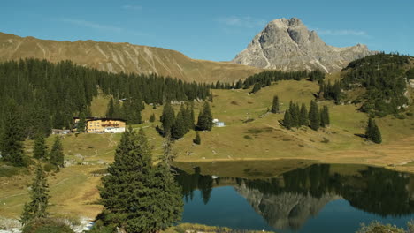 Zooming-in-of-a-house-by-the-lake-from-Korbersee-lake-in-Austria