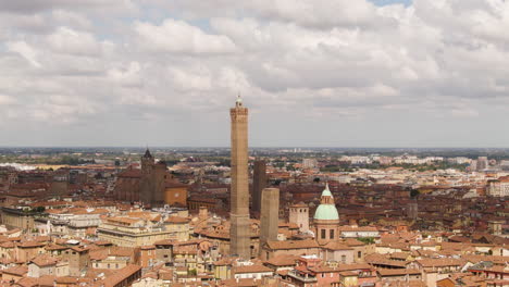 Bologna-cityscape-with-churches-and-majestic-tower,-aerial-orbit-view