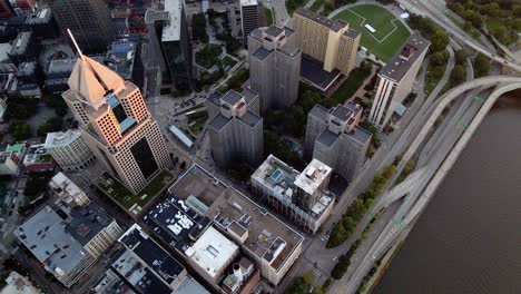 Aerial-view-riverside-buildings-and-the-Fort-Duquesne-blvd-Pittsburgh,-Pennsylvania,-United-states---tilt,-drone-shot
