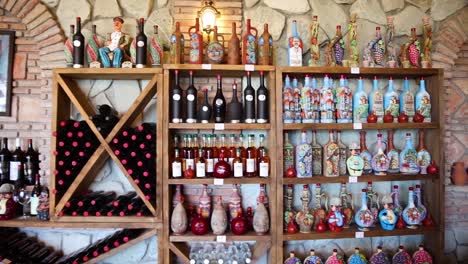 Selection-Of-Wine-Bottles-On-Wall-Shelf-At-Restaurant-In-Georgia