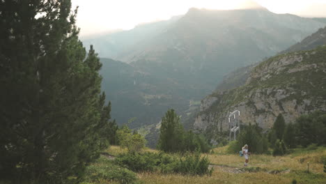 Blonde-woman-hiking-in-the-mountains-of-Benasque,-Spain,-panoramic-shot