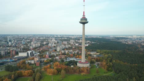 AERIAL:-Vilnius-TV-Tower-on-a-Autumn-Season-with-City-in-Background