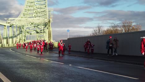 Slow-motion-Charity-Santa-dash-fun-run-competition-across-Runcorn-Silver-Jubilee-bridge