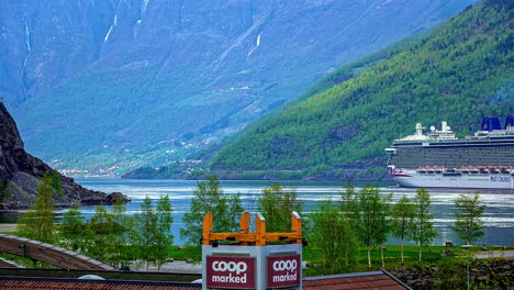 Timelapse-shot-of-giant-P-and-O-Cruise-Ship-in-motion-in-Norwegian-Fjord-in-Flam,-Norway-during-summer-with-lush-green-vegetation-on-mountainous-terrain-all-around-at-daytime-in-2019