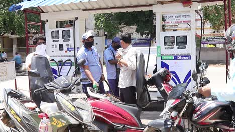 Petrol-pump-employee-fills-up-fuel-in-a-motorbike