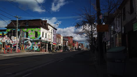 Wide-shot-of-pedestrians-walking-on-a-nearly-empty-Queen-Street-West-during-COVID-times