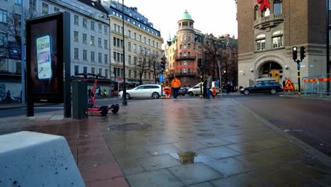 Dynamic-movement-of-pedestrians-and-traffic-on-the-intersection-at-street-in-Stockholm,-Sweden