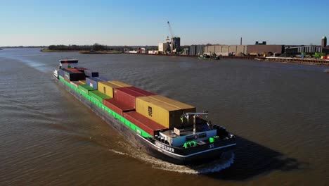 Aerial-Forward-Bow-View-Of-Sendo-Liner-Inland-Freighter-Along-Der-Lek-In-Groot-Ammers-With-Pedestal-Up-Tilt-Down-Reveal