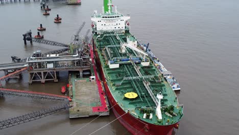 Silver-Rotterdam-oil-petrochemical-shipping-tanker-loading-at-Tranmere-terminal-Liverpool-aerial-view-Birdseye-orbit-left