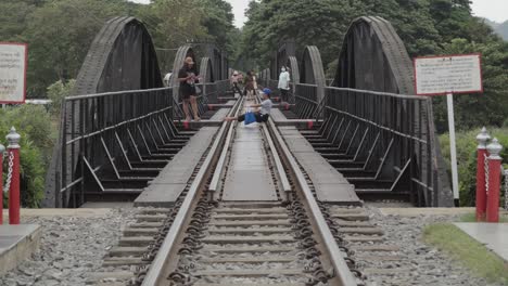 A-distant-shot-of-Thai-tourists-posing-to-take-photographs-on-the-railway-track-at-the-Bridge-over-the-River-Kwai