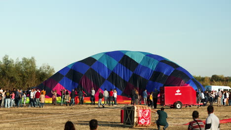 Inflating-Colorful-Hot-Air-Balloon-During-International-Ballooning-Festival-In-Coruche,-Portugal