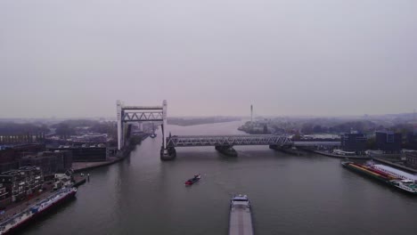 Aerial-View-Of-Raised-Spoorbrug-Railway-Bridge-Over-Oude-Maas-On-Cloudy-Day
