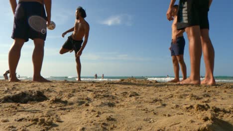 Skilled-boys-have-fun-playing-football-on-summer-holidays-on-sandy-beach-in-Italy