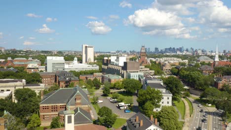 Aerial-Pedestal-Up-Reveals-Cambridge,-Massachusetts-with-Boston-Skyline-in-Background