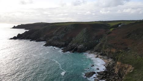 Aerial-forward-along-rocky-coast-of-Minack-in-Cornwall,-England