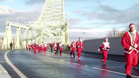 Slow-motion-Charity-Santa-dash-fun-marathon-run-across-Runcorn-Silver-Jubilee-bridge