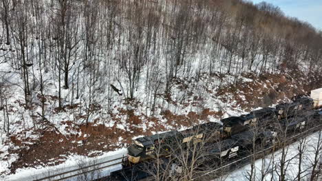 Norfolk-Southern-diesel-locomotives-pass-on-railroad-train-tracks-in-winter-snow
