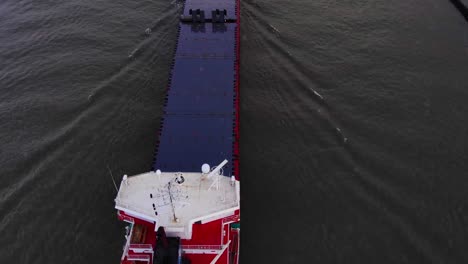 Aerial-Over-Deck-Of-Ameland-Cargo-Ship-With-Slow-Tilt-Up-As-It-Navigates-Along-Oude-Maas