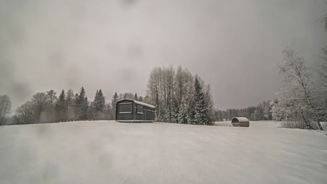 Thermowood-Cabins-On-Snowy-Landscape-On-A-Dramatic-Weather