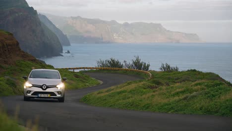 Car-driving-on-winding-coastal-panoramic-route-on-Madeira-island,-Road-to-Ponta-do-Rosto