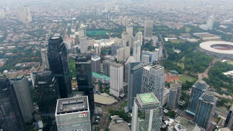 Aerial-backward-over-skyscrapers-at-Sudirman-Central-Business-District-or-SCBD,-Jakarta-in-Indonesia