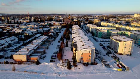City-of-Svitavy-covered-with-snow-at-sunset-in-winter,-drone-shot---Czech-Republic