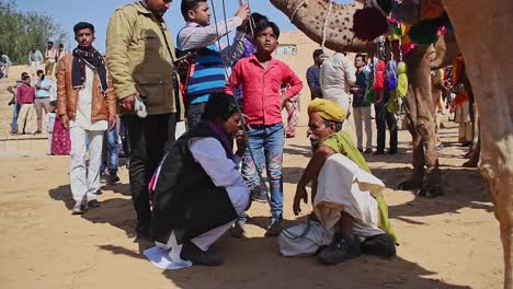 Two-person-sits-and-talks-to-each-other-in-the-middle-of-the-middle-of-The-Heritage-Walk-of-The-Desert-Festival