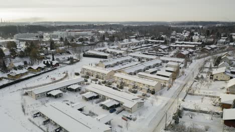Aerial-forward-moving-view-of-Pitkämäki-residential-row-house-area-in-winter-time-when-everything-is-covered-in-snow