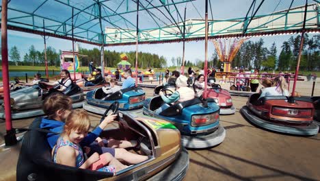 Ledmane-Parish,-Latvia---May-30,-2021:-Amusement-Park-Abpark-People-Ride-Multicolored-Electric-Cars-in-the-Autodrome-and-Have-Fun