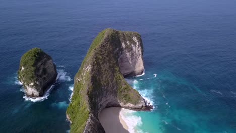 Stunning-aerial-view-flight-sideways-for-a-adventure-commercial-advertising-Kelingking-Beach-at-Nusa-Penida-in-Bali-Indonesia-is-like-Jurassic-Park-Cinematic-nature-cliff-view-above-by-Philipp-Marnitz