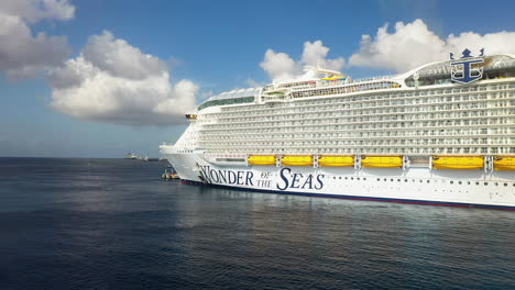 Drone-shot-of-the-Wonder-Of-The-Seas-Royal-Caribbean-cruise-ship-docked,-zooming-in