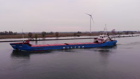 Aerial-Tracking-Shot-Along-Port-Side-of-Torpo-Cargo-Ship-Along-Oude-Maas-During-Overcast-Day