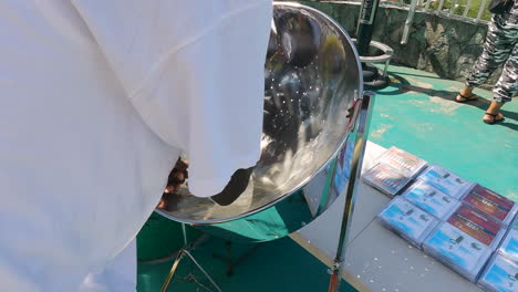 Slow-motion-close-up-shot-of-a-man-playing-on-a-steelpan-drum-in-Saint-Thomas