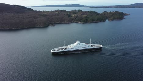 Aerial-following-ships-side-of-ferry-Flatoy-transporting-cars-between-Halhjem-and-Sandvikvaag-along-road-E39-in-Norway---Lng-and-battery-powered-ferry-underway-to-Sandvikvag