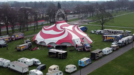 Planet-circus-daredevil-entertainment-colourful-swirl-tent-and-caravan-trailer-ring-aerial-view-descend-left