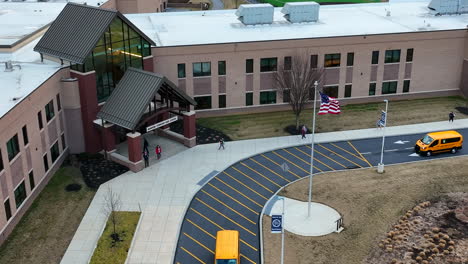 Yellow-van-transports-students-to-American-school-entrance