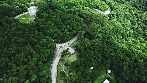 A-dynamic-tracking-aerial-shot-of-a-travelling-bus-on-the-winding-roads-of-the-Tai-Mo-Shan-mountains-in-Hong-Kong