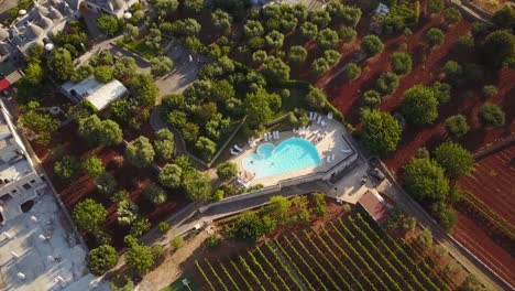 Top-view-of-a-pool-in-the-italian-countryside,-mavic-drone-aerial-shot