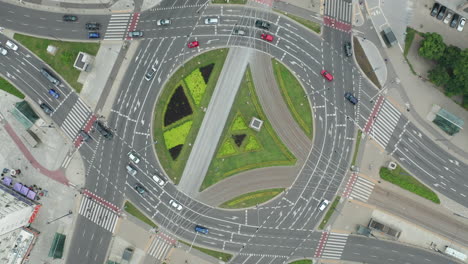 Aerial-drone-top-down-view-of-the-ONZ-roundabout-in-the-center-of-Warsaw-with-passing-cars-at-cloudy-day